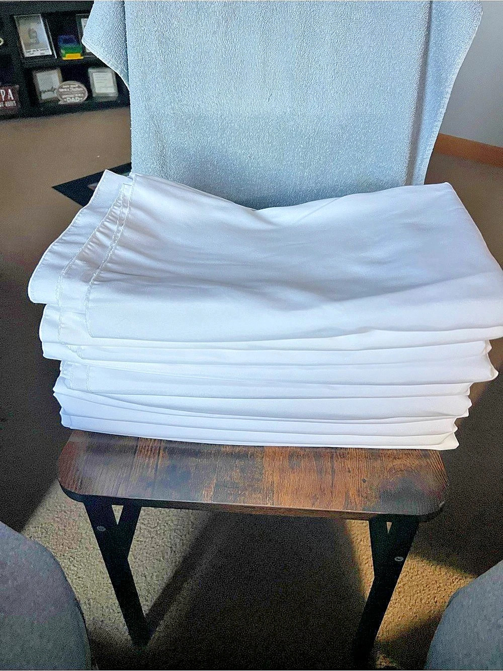 Stack of white folded table cloths 5ft x8ft , 10 count